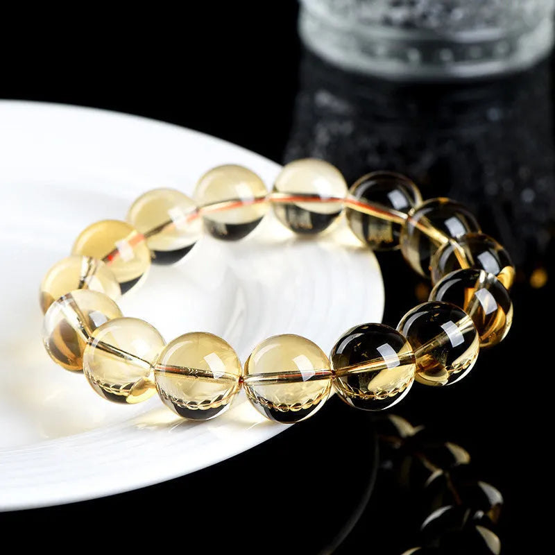 Natural citrine scattered beads ball bracelet showing polished stones in yellow-amber hues on a white background.