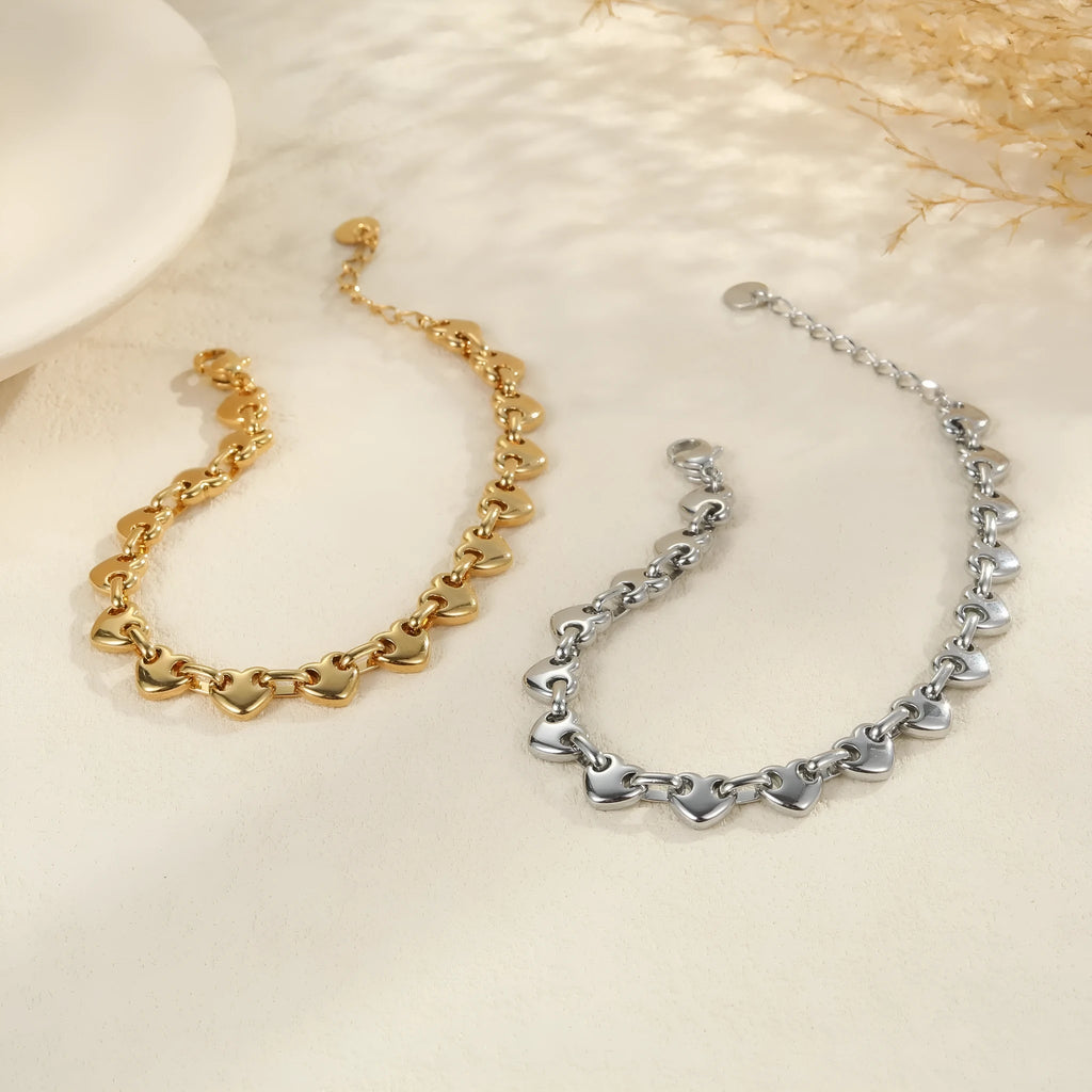 Women's geometric hollowed-out heart bracelet in stainless steel, available in gold or steel colour.