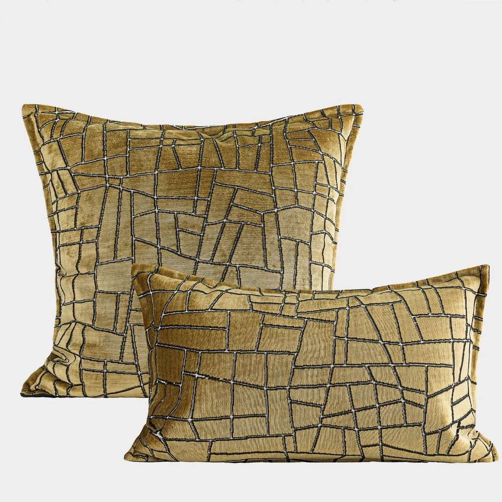 Gold geometric pattern decorative cushion cover shown in square and waist pillow sizes on a grey sofa.