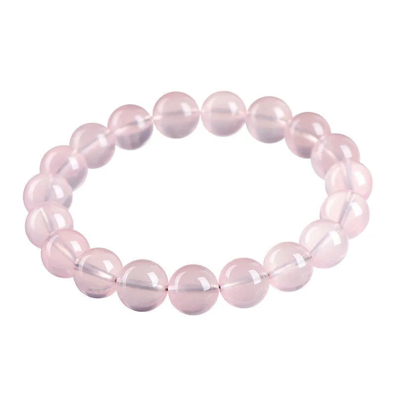 Women's natural style bracelet with round polished crystal beads in pink, showing size options from small to large beads.