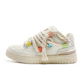 Creamy white low-top retro skate shoes with lace-up front and platform sole.