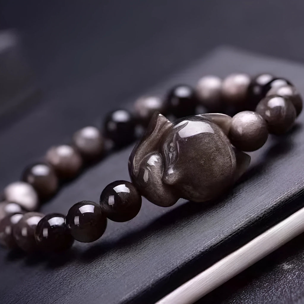 Obsidian fox bracelet with 8mm polished bead and fox charm on black elastic cord
