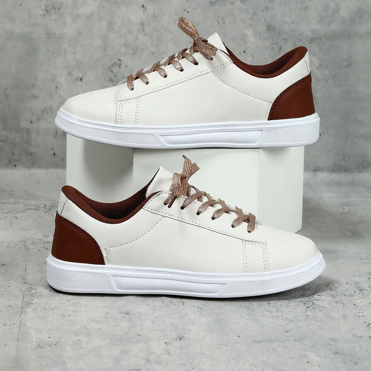 Beige brown platform skateboard sneaker with low top, round toe, and cross-belt design on a white background.