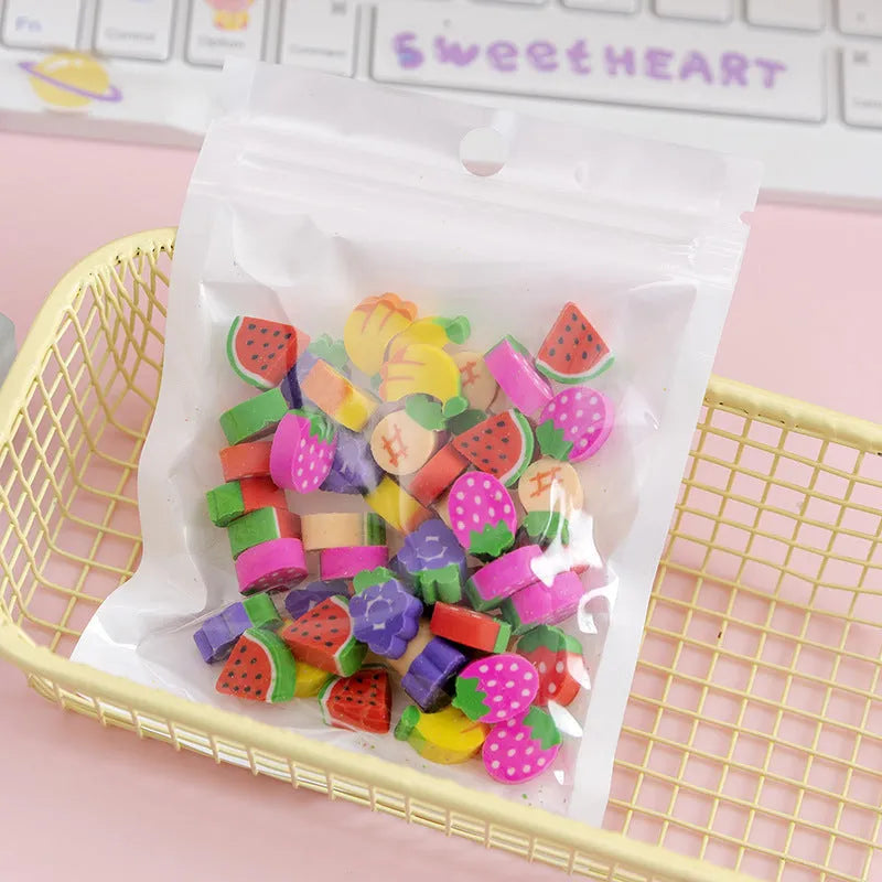 50 small colourful cartoon erasers in a pearlescent bag showing fruit, animal, cake, and Halloween themes.