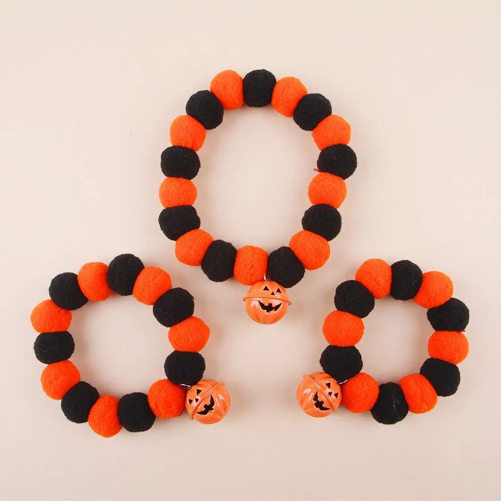Orange and black Halloween pumpkin pet collar with jingle bell and buckle fastener for cats and dogs