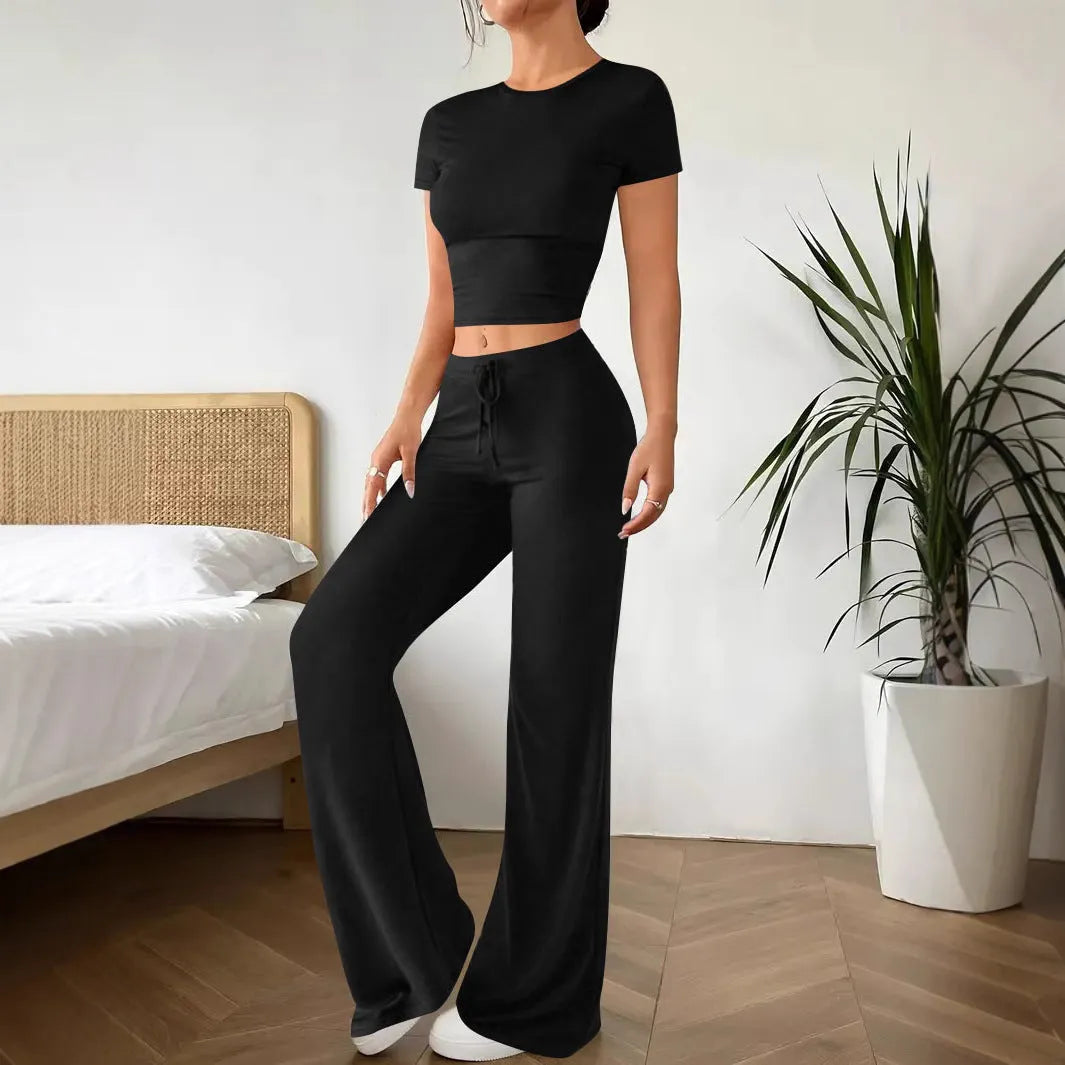 Women's black high waist trousers and short sleeve T-shirt suit set on a hanger