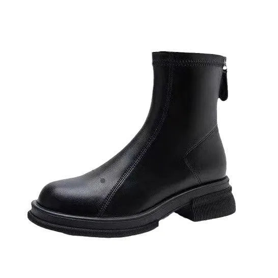 Women's black ankle boot with flat heel, round toe, and back zip on a plain background.