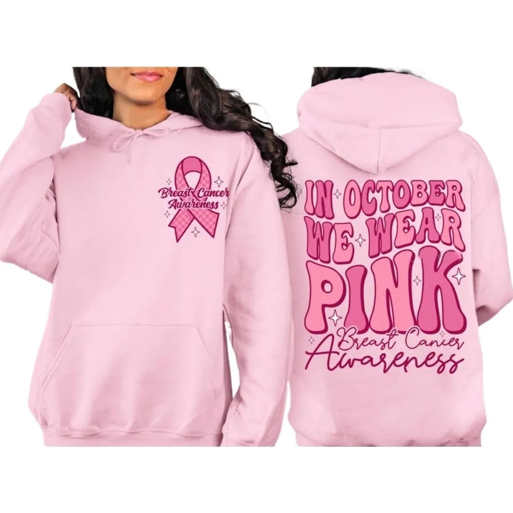 Pink pullover hoodie with a breast cancer awareness slogan, retro graphic, and side seam pockets.
