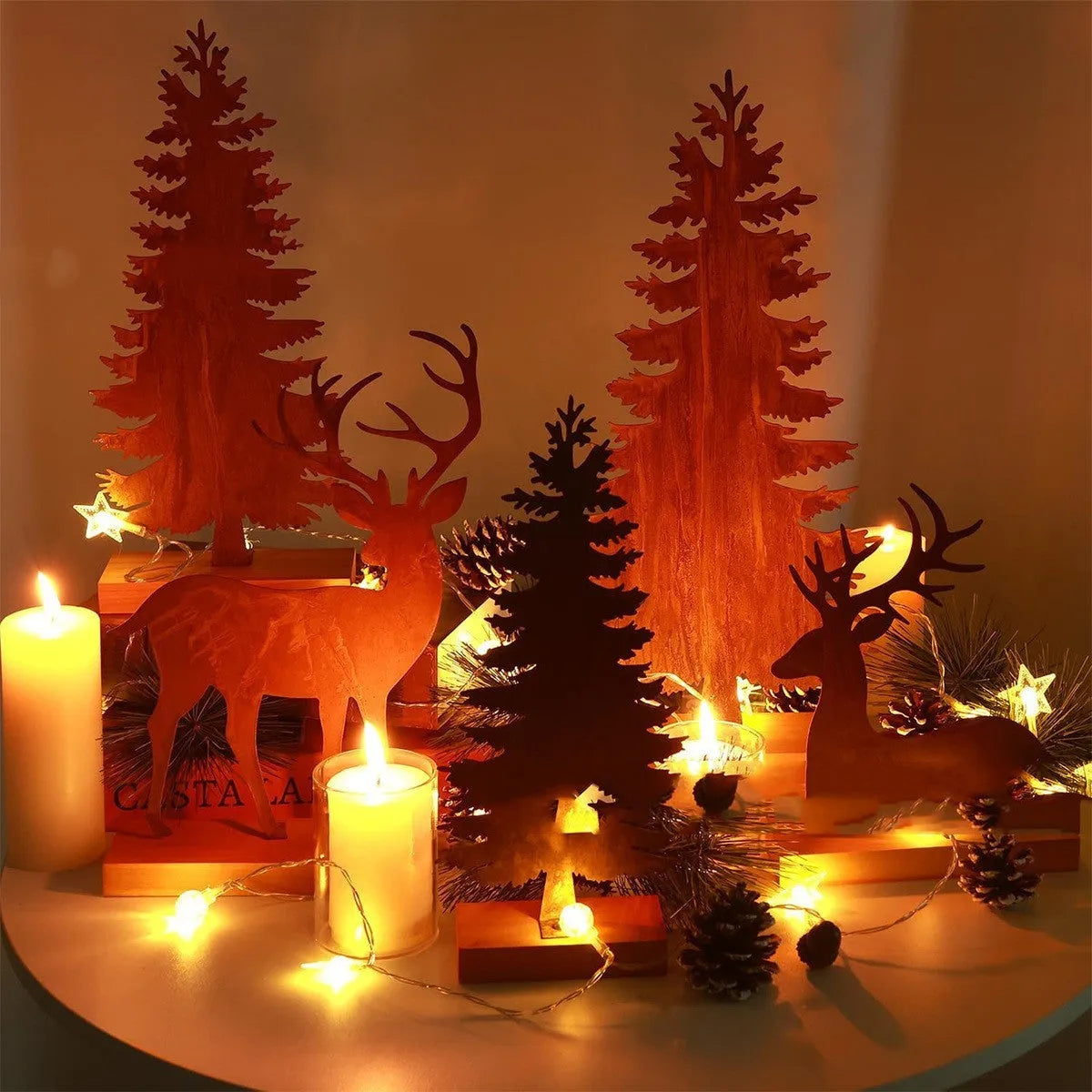 Three metal Christmas tree ornaments with elk motifs in rustic patina finish