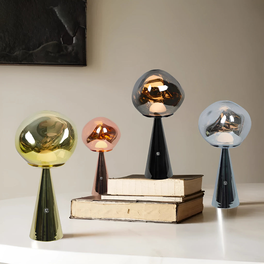 Volcanic lava mini table lamp with metal holder in gold finish, USB magnetic charging, on a bedside table