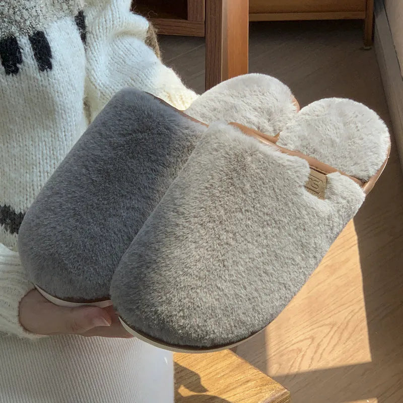 Solid colour PVC plush slippers with non-slip sole and car stitching detail on a wooden floor.