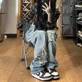 Blue high-waisted women's wide-leg denim trousers laid flat, showing straight-leg cut and front details.
