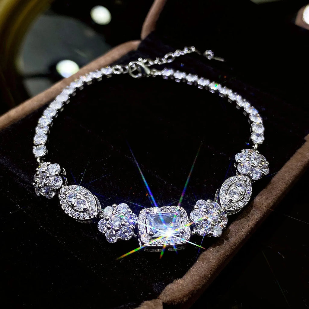 Women's geometric bracelet with zircon stones on silver-toned band showing adjustable and fixed length options