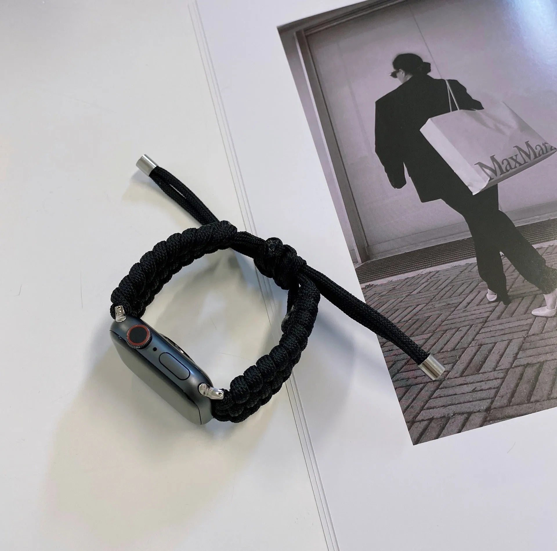 Paracord braided smartwatch strap in black, shown attached to an Apple Watch.