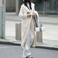 Long grey knitted hooded cardigan trench coat on a hanger showing its 80cm length and thick texture.