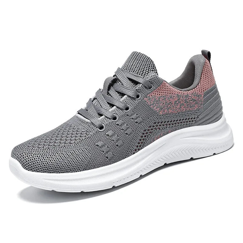 Women's low-top black mesh sneakers with round toe and white PVC sole, shown with lace-up front.