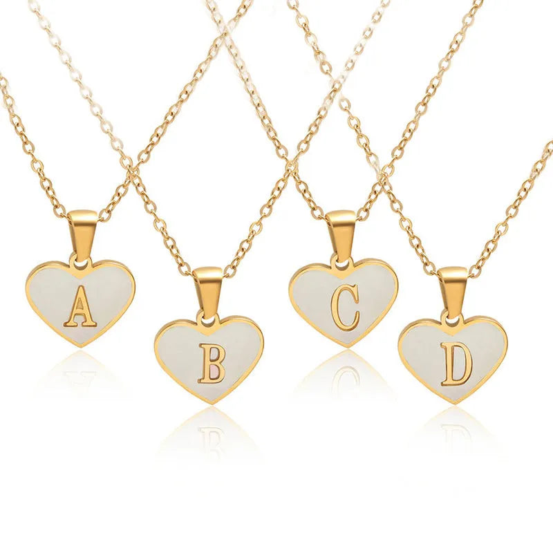 Gold plated heart-shaped personalised necklace with white shell charm on an adjustable chain.