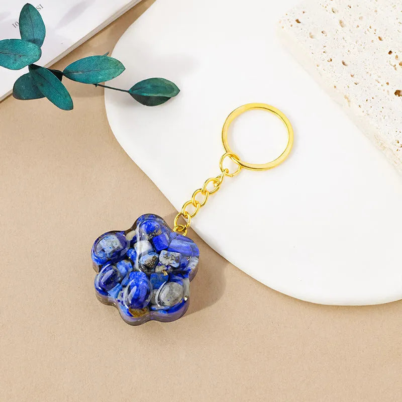 Natural crystal cat's paw keychain pendant in various gemstone colours including pink, red, blue, and green