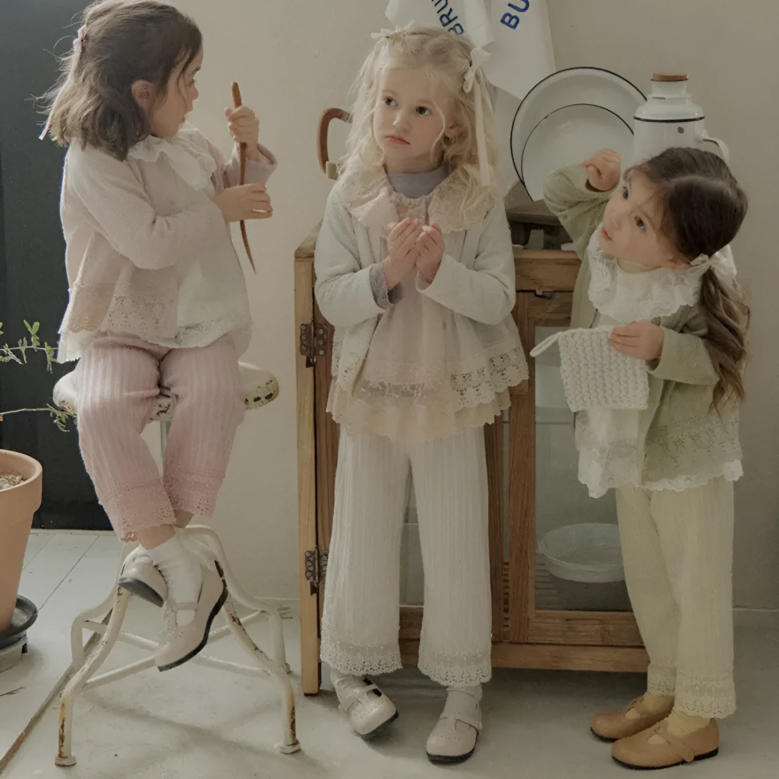 Girls loose knitted lace trim straight-leg trousers in pink, apricot, and white colours