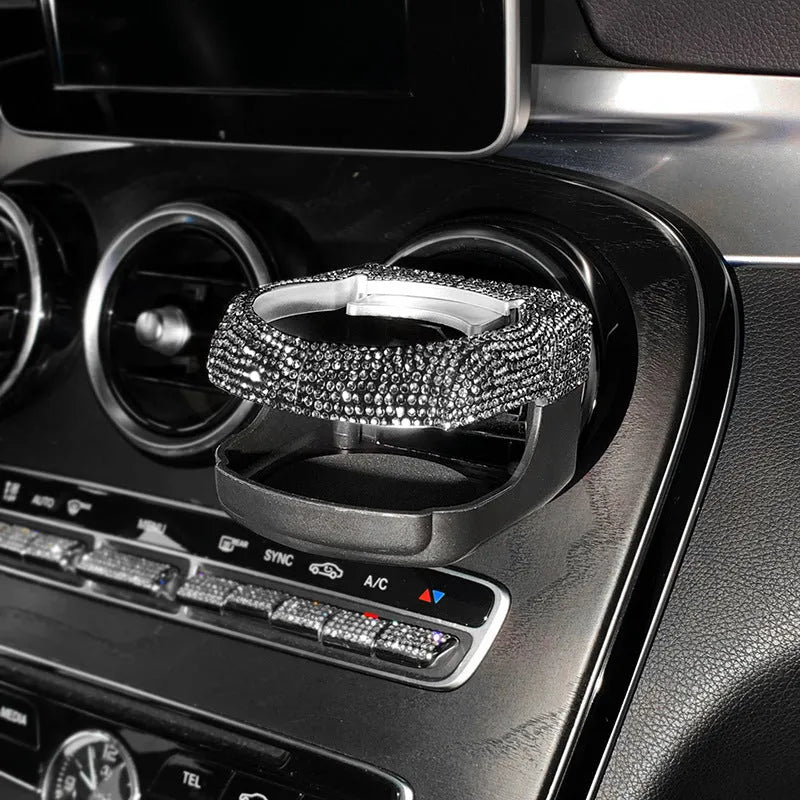 White diamond decorated ABS plastic car vent cup holder mounted in a car air vent.