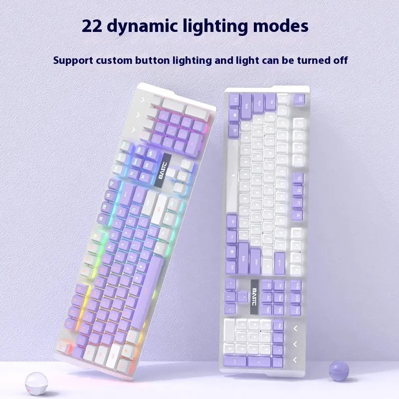 Purple and white mechanical keyboard and mouse wired set with backlight illumination on desktop
