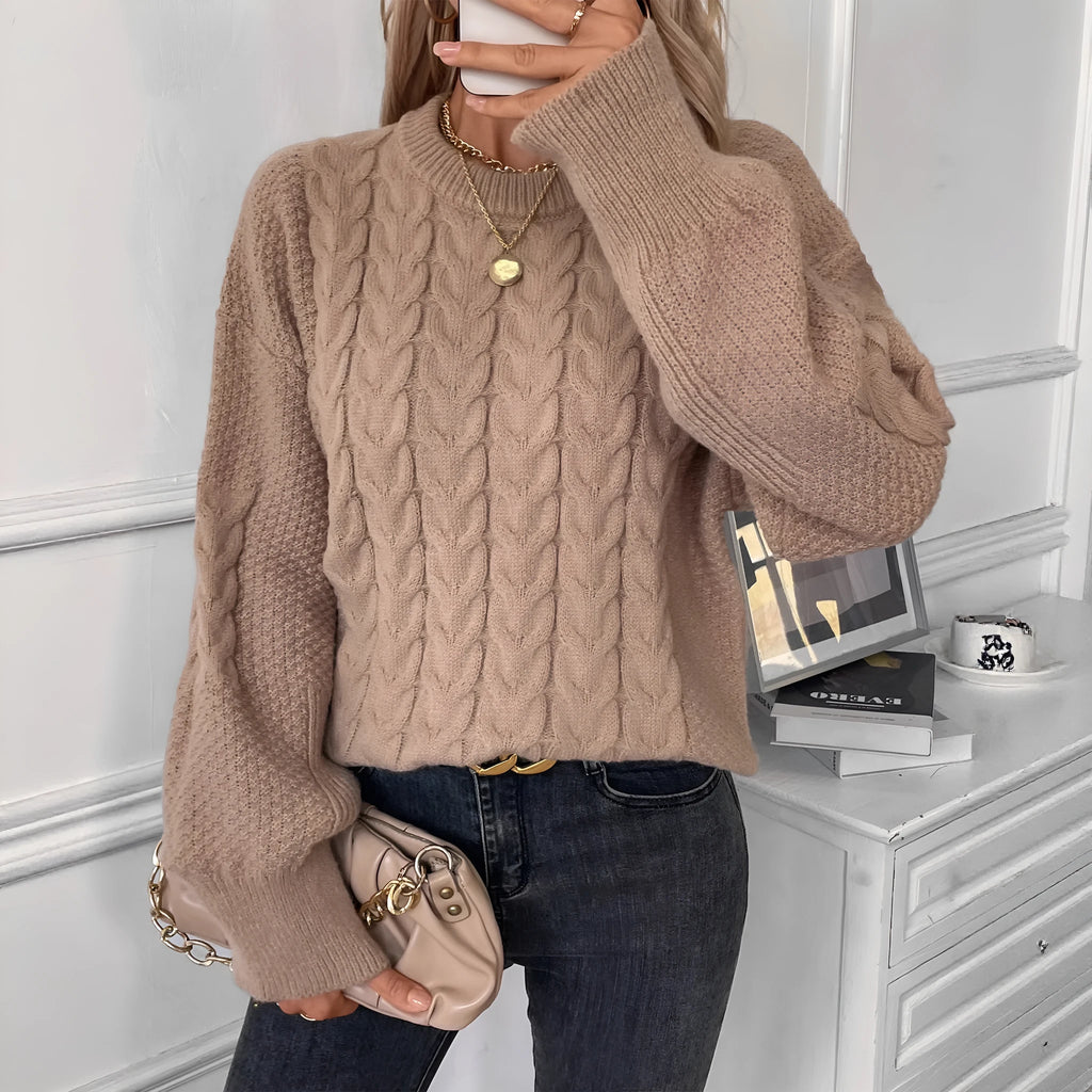 Women's beige loose round neck casual polyester sweater on a hanger.