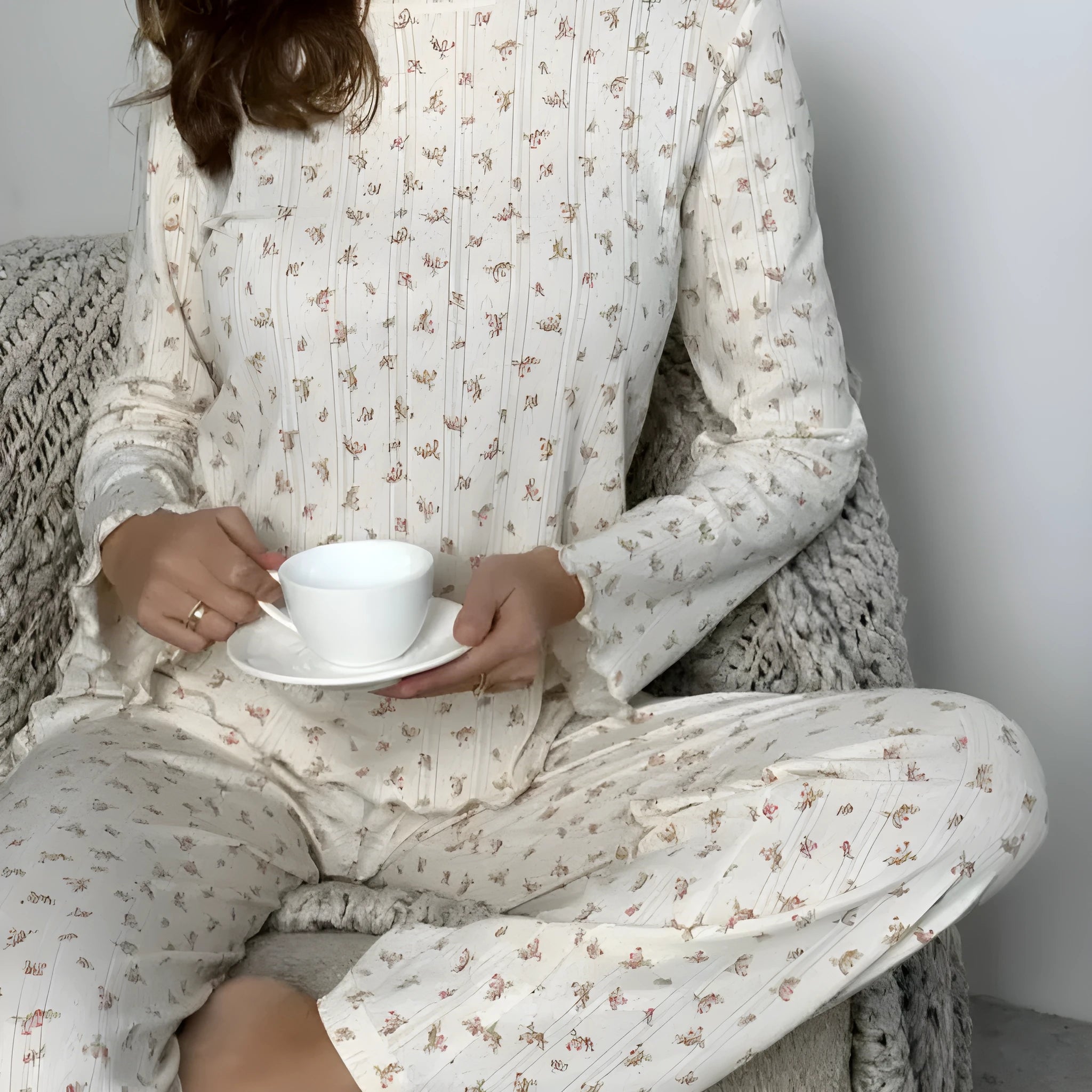 White women's floral print bell sleeve top and wide leg pants casual suit set laid flat