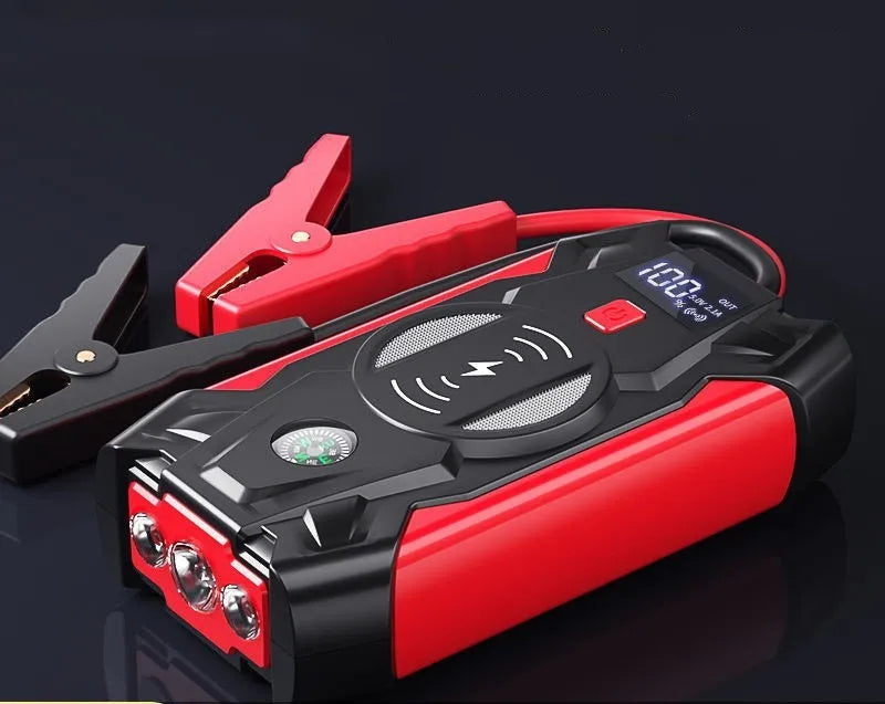 Red car emergency jump starter power pack showing digital display and battery clips