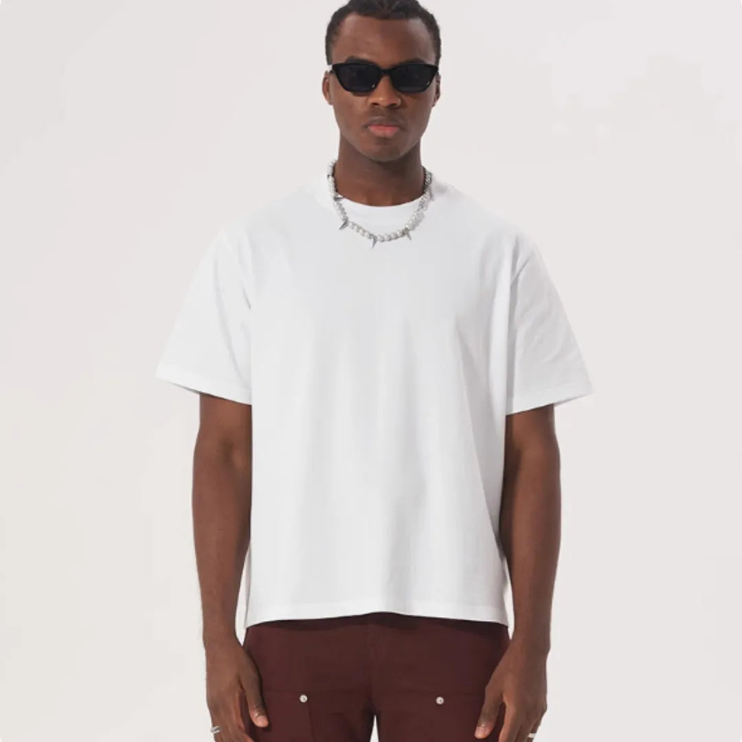 Man wearing a loose fit apricot coloured pure cotton t-shirt, short sleeves, casual American style.