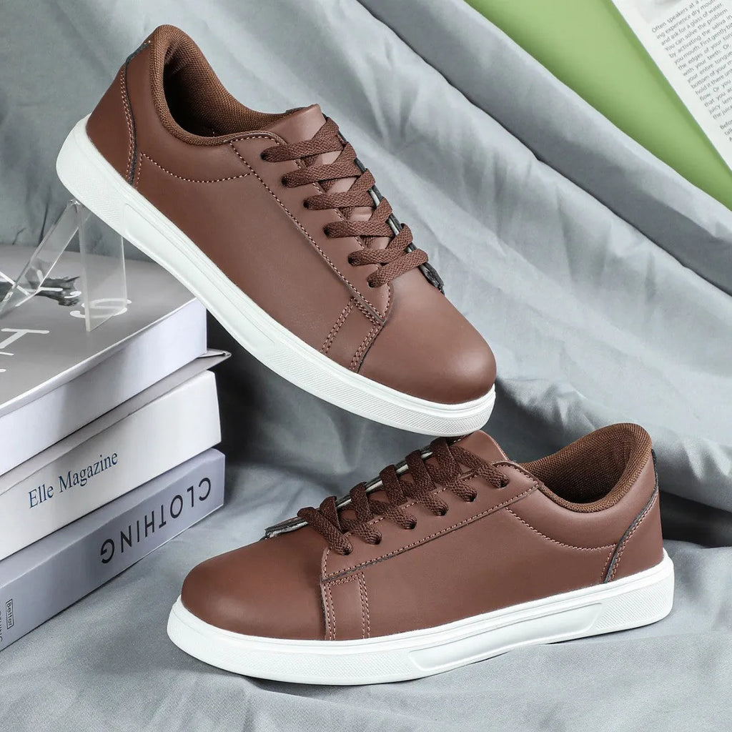 Beige brown platform skateboard sneaker with low top, round toe, and cross-belt design on a white background.