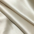 Dark grey mulberry silk pillowcase with an envelope closure on a bed.