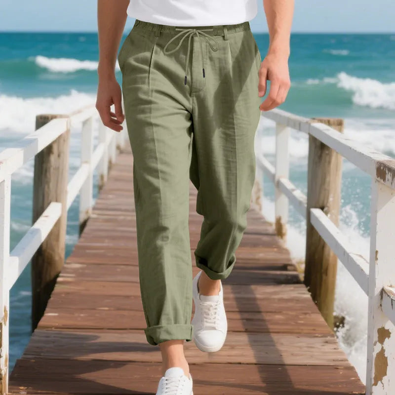 Men's loose-fit straight-leg linen trousers in light khaki colour with a drawstring waist.