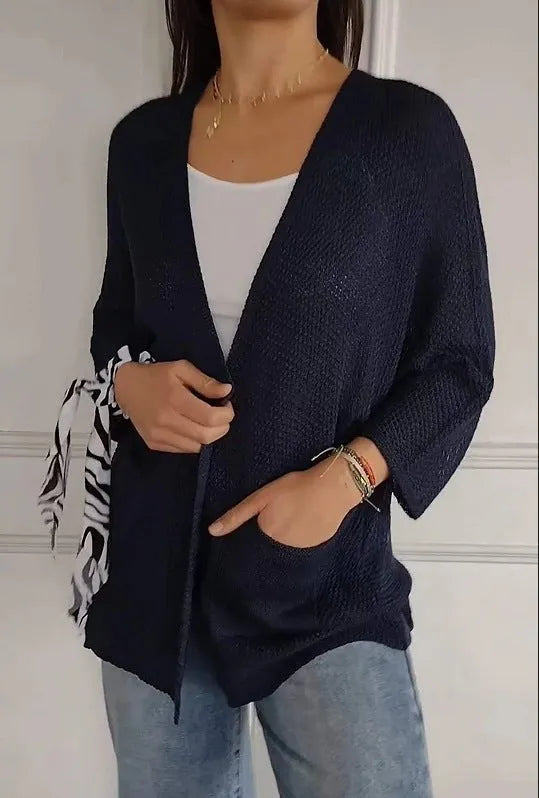 Women's thin waffle weave cardigan coat in army green with pockets, shown on a hanger.