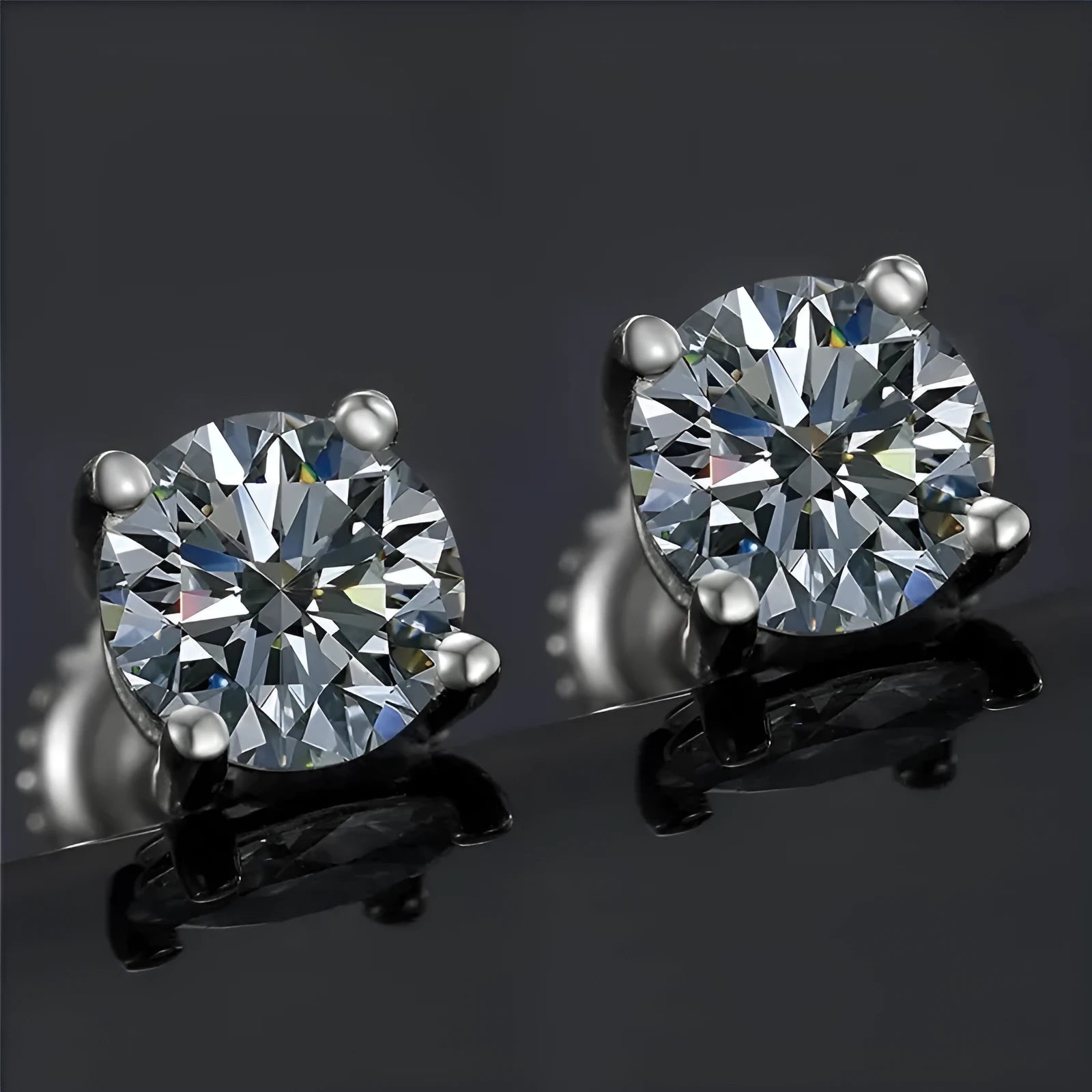 Silver moissanite screw-back stud earrings with four-claw setting on black card