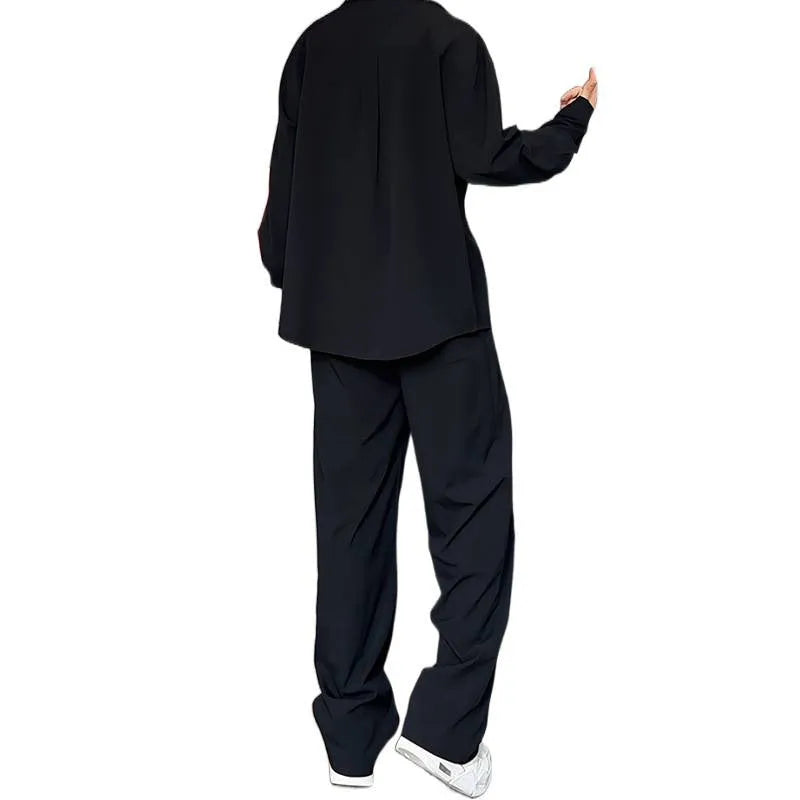 Men's black slim fit two-piece casual suit with long sleeve polo shirt and trousers on a hanger.