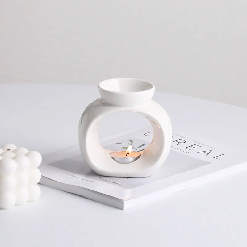 White Nordic style ceramic aromatherapy stove ornament on a table.