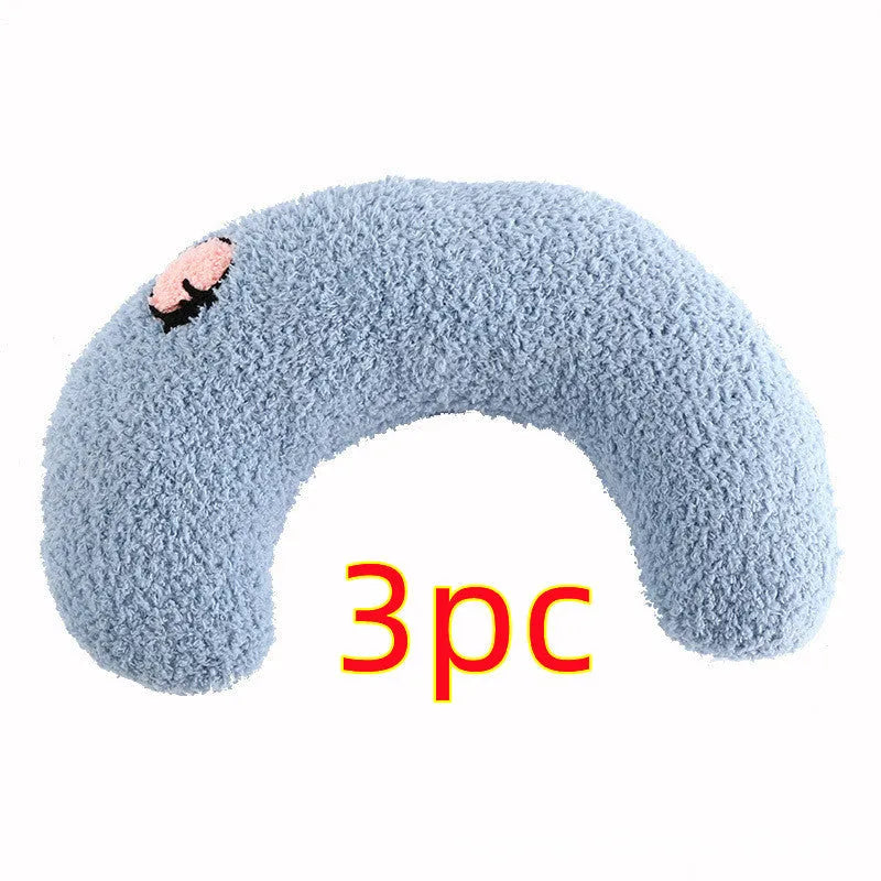 Small blue U-shaped plush pillow for cats or small dogs on a white background.