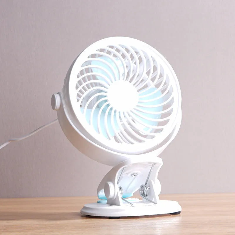 Small white USB desk fan shown in clip-on and floor-standing styles on a wooden desk.