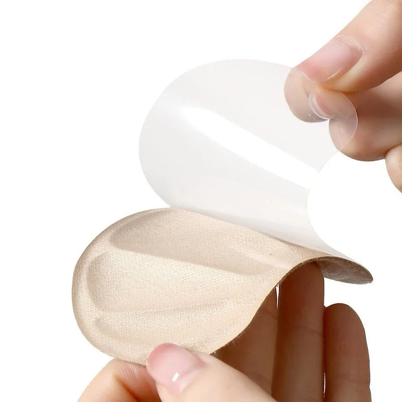 Camel-coloured suede anti-blister heel cushion pads with adhesive backing.
