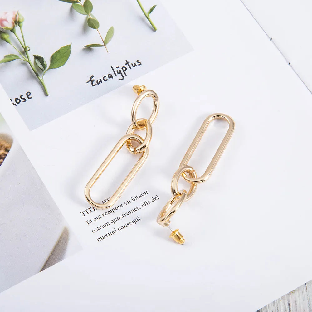 Geometric sterling silver tone hoop earrings for women with a ring and line design.