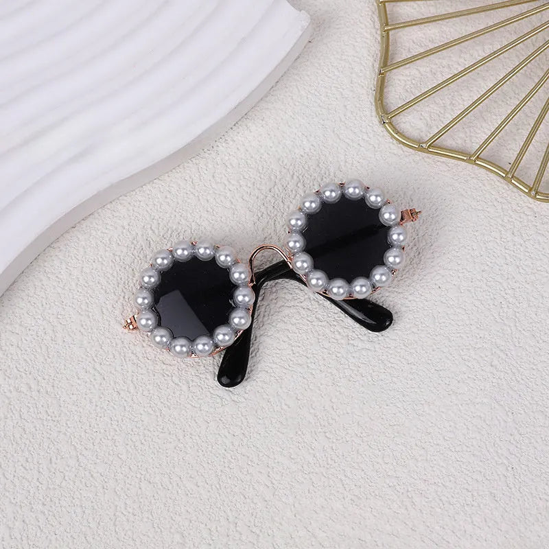 Pearl-rimmed round sunglasses for cats and dogs in multiple colours as costume accessories