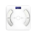 White smart Bluetooth body fat scale on bathroom floor showing digital display