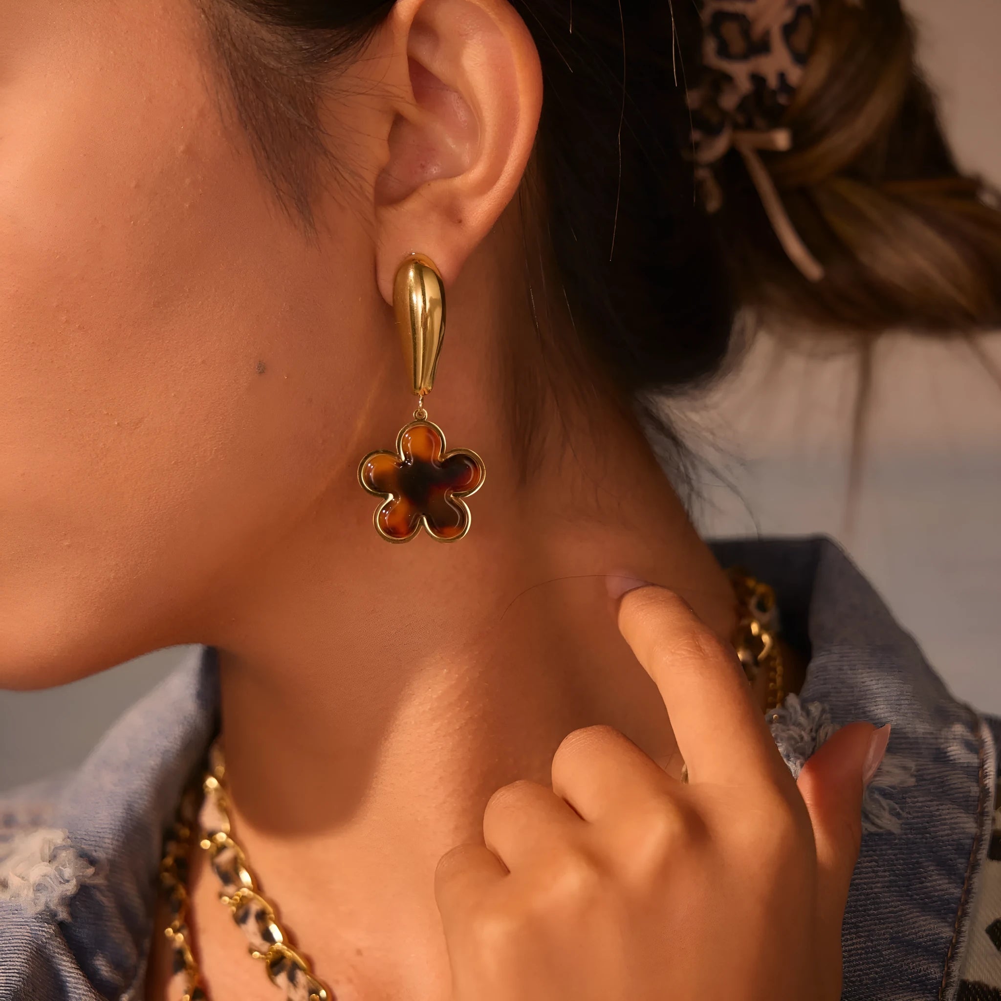 Gold electroplated tortoiseshell resin earrings in heart and geometric floral designs for women.