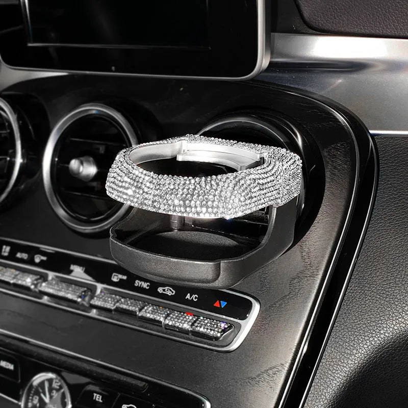 White diamond decorated ABS plastic car vent cup holder mounted in a car air vent.
