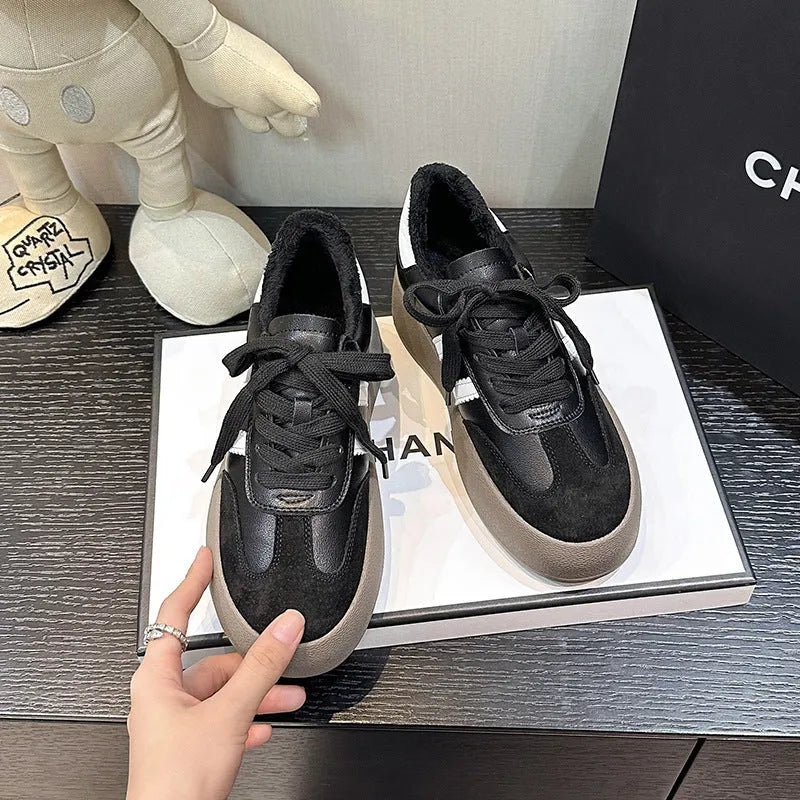 Women's beige distressed leather lace-up sneakers with round toe and rubber sole on a neutral background.