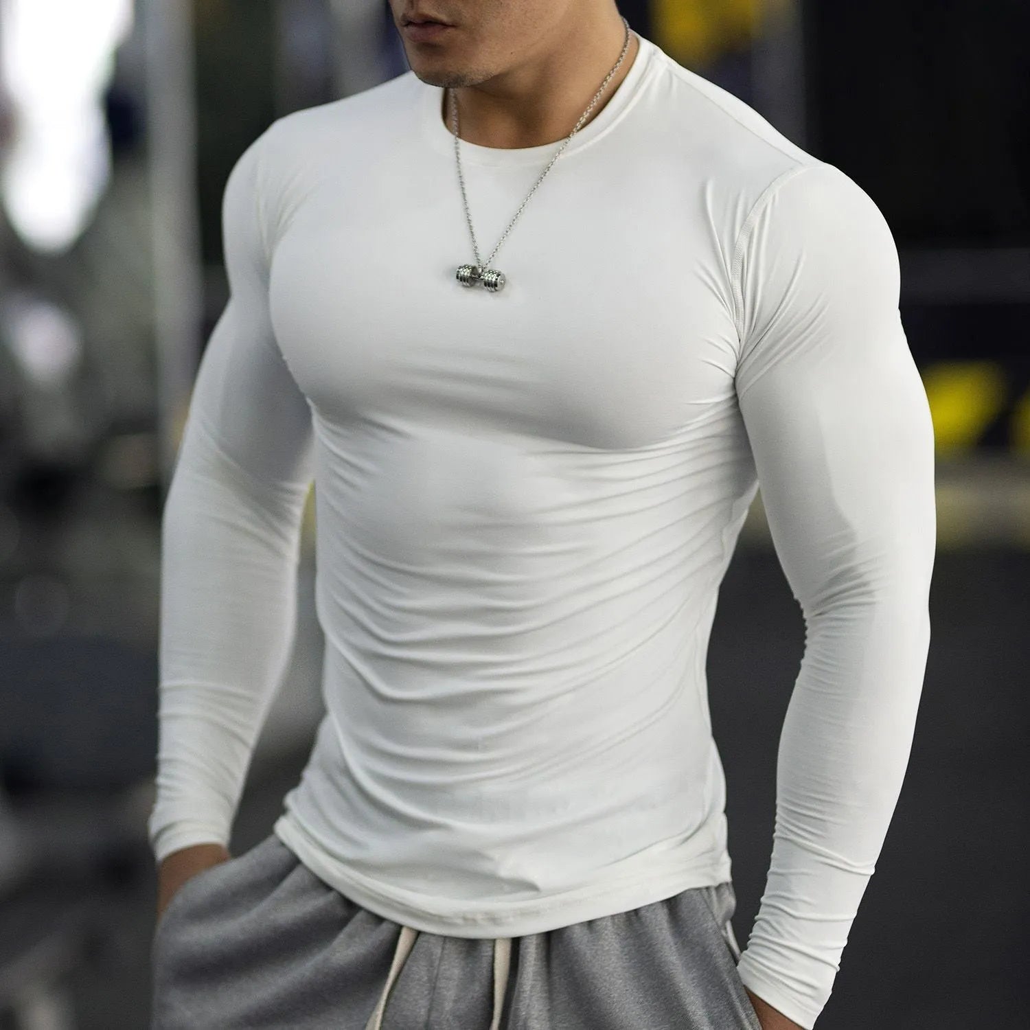 Men's black slim-fit fitness tights with long sleeves for gym and running.