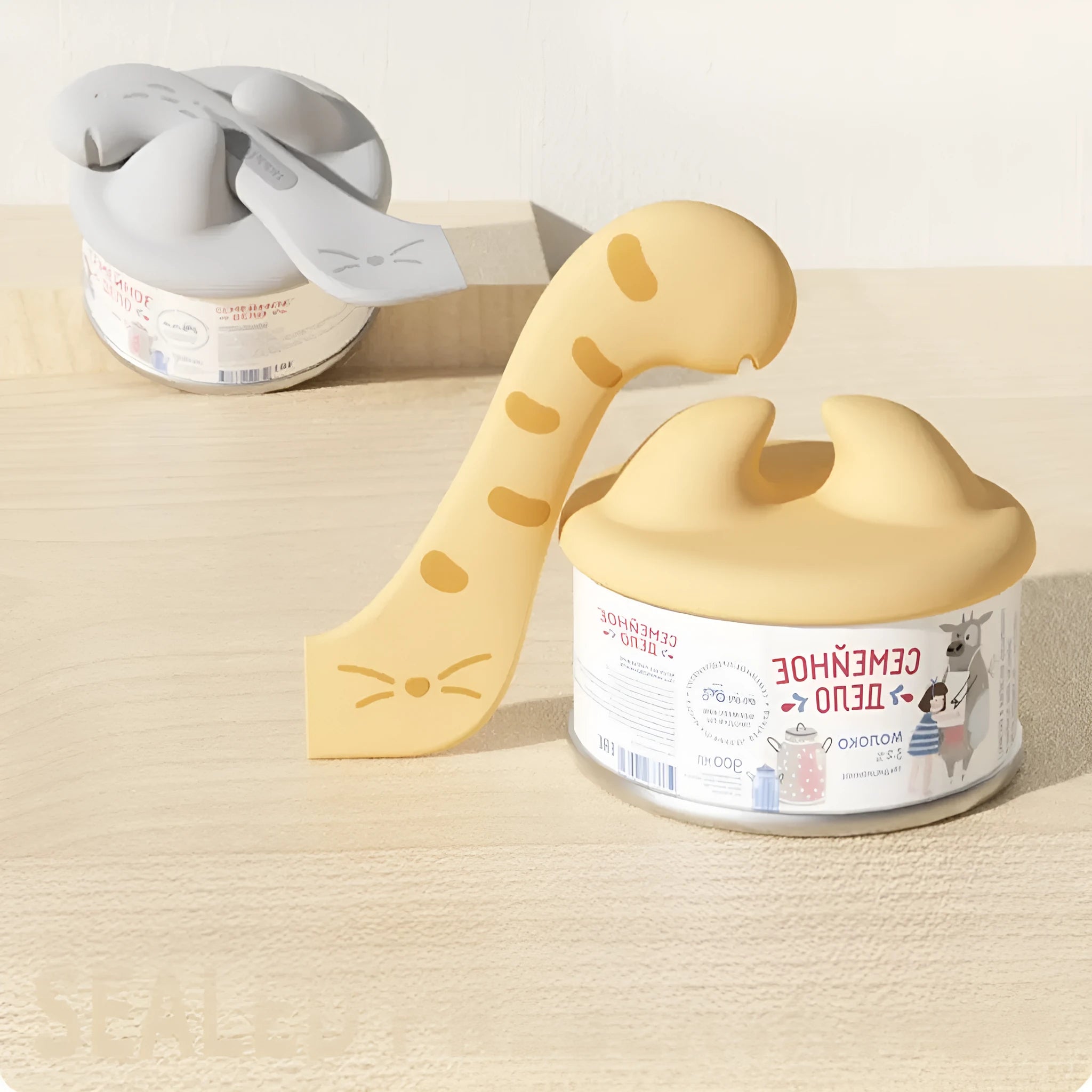 ABS silicone cat jar spoon can opener and feeding tool in grey on a surface
