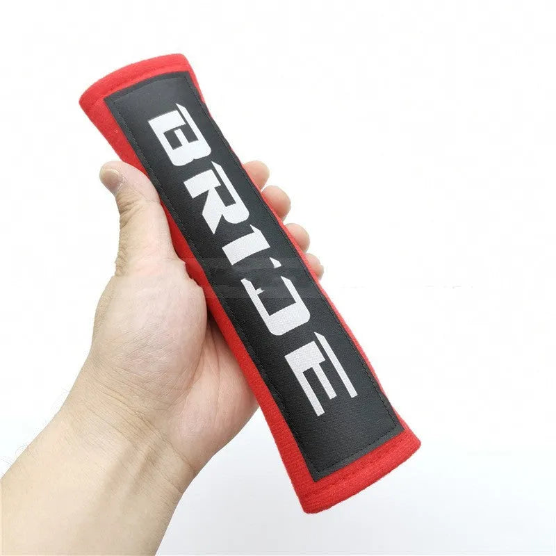 Black cotton sponge cloth car seat belt shoulder pad showing embroidery weaving texture and 22.5cm length