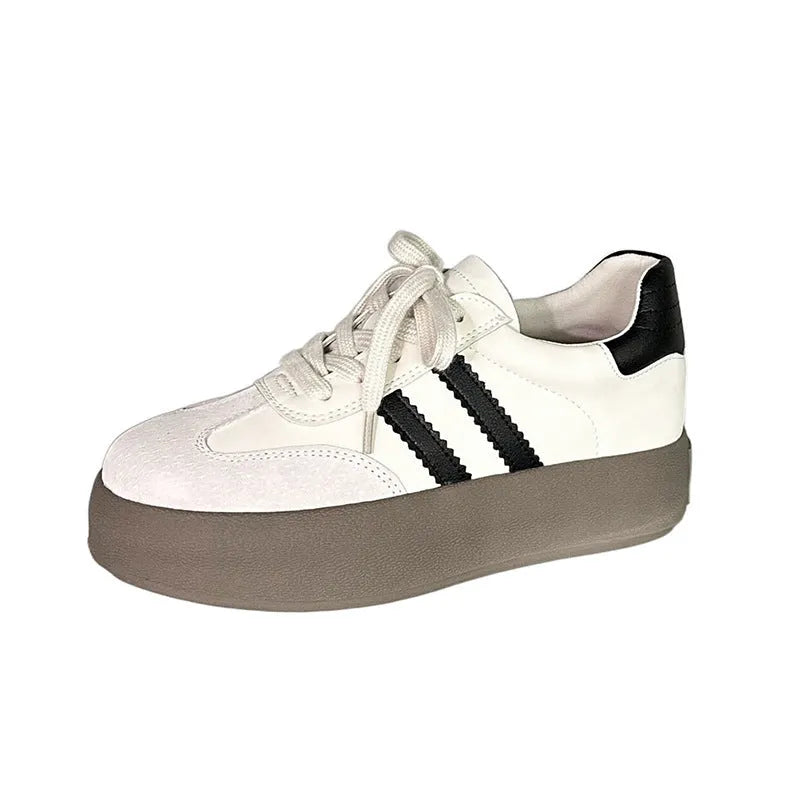 Women's beige distressed leather lace-up sneakers with round toe and rubber sole on a neutral background.