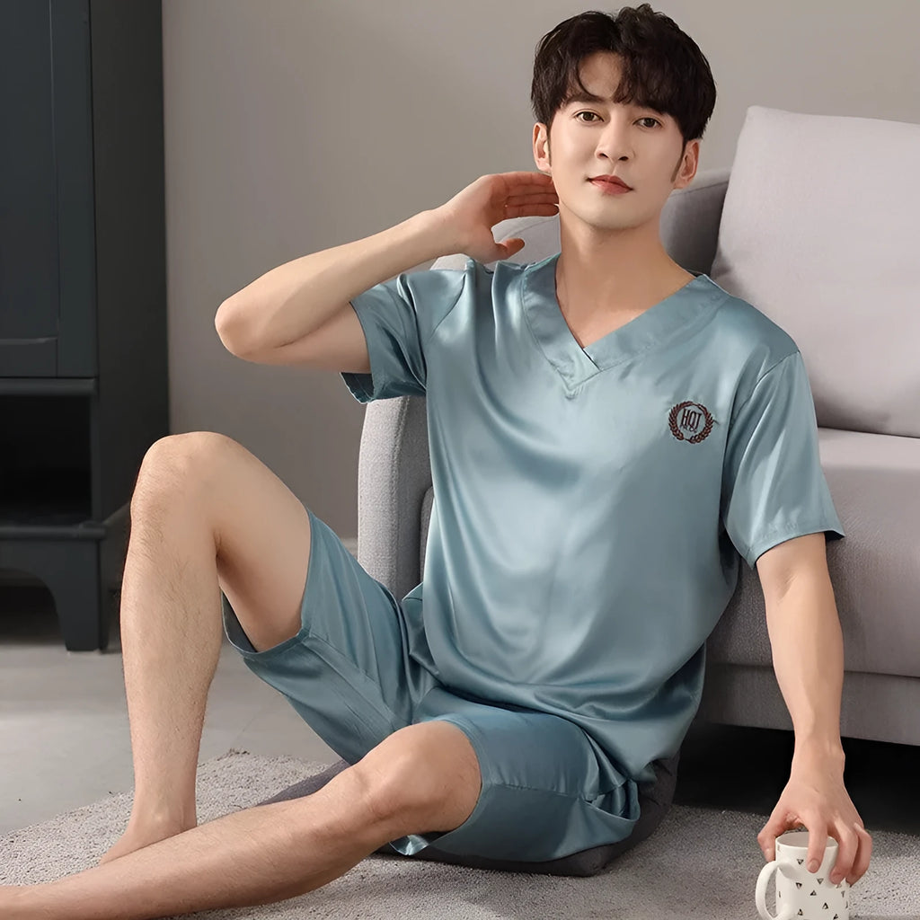 Man's ice silk short-sleeve pyjama shirt and shorts set in a loose, comfortable fit on a hanger